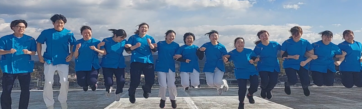青空のもとで笑顔でジャンプする看護スタッフたち